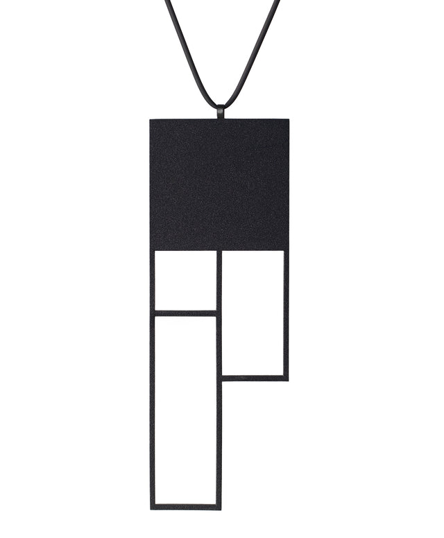A large rectangular black sculptural necklace from the KONZUK Artus collection called Ratio Rp6