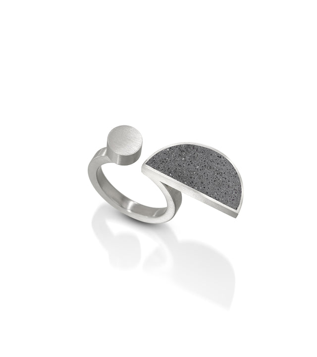 The Dorte ring captures the spirit of Dorte Helm's geometric textile designs and is a modern homage to the Bauhaus ethos. Like Dorte's commitment to striking patterns, these rings seamlessly merge simple geometry with everyday elegance, offering a contemporary expression of the Bauhaus tradition in concrete and stainless steel.