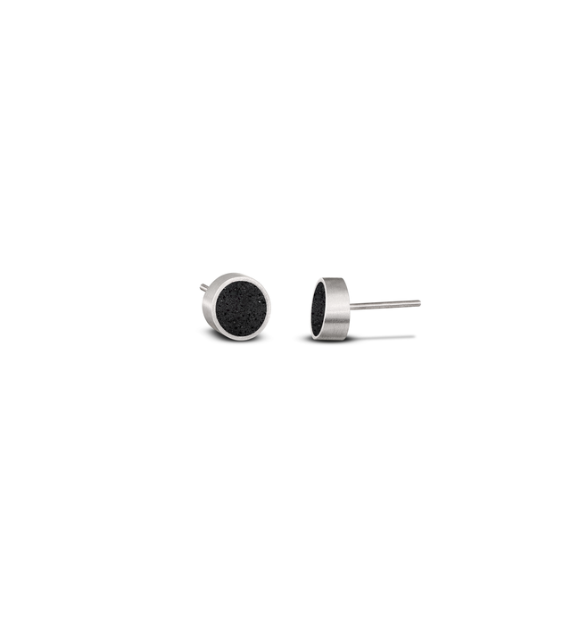 These modern stainless steel stud earrings—with circular black concrete inlays—play homage to the minimalist Bauhaus geometric designs of Herbert Bayer.