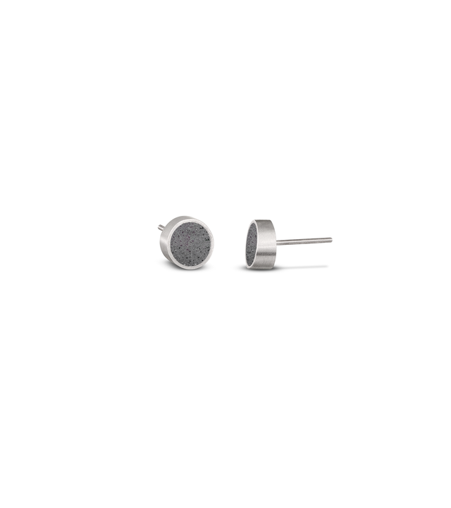 These uniquely skewed circular stainless steel stud earrings—with concrete inlays—play homage to the geometric designs of Herbert Bayer.