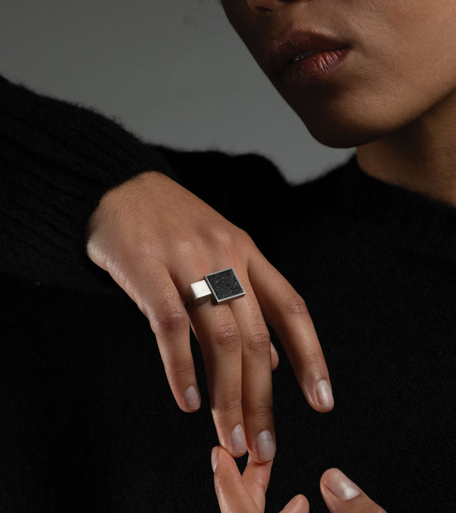 This architectural ring inspired by Theo van Doesburg combines the raw industrial beauty of concrete, set in brushed stainless steel for a striking contrast of textures. The bold geometric design brings De Stijl modernism to your everyday style, making a confident statement that bridges art and fashion while remaining surprisingly comfortable and wearable.