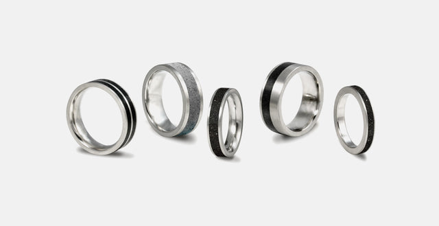 Group of concrete and stainless steel wedding rings.