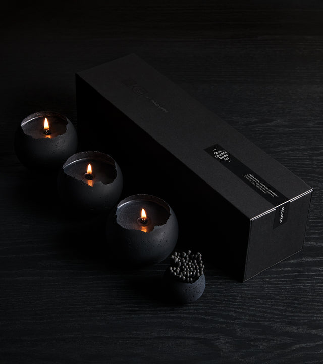 a box set of three black orbis candle with black wax from the KONZUK Nocturnal Orbis candle collection including a small holder with black matches
