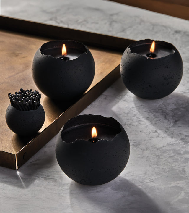 a box set of three black orbis candle with black wax from the KONZUK Nocturnal Orbis candle collection including a small holder with black matches