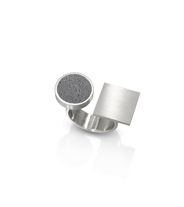 The dynamic composition of this ring captures Bortnyik's constructivist vision, creating a wearable balance between opposing shapes and textures that feels both playful and sophisticated. Its architectural presence makes a powerful style statement while remaining comfortable for everyday wear, with the interplay of matte concrete soft metal finish catching light from every angle. for those who embrace avant-garde aesthetics, this ring transforms modernist art principles into a striking piece of wearable art