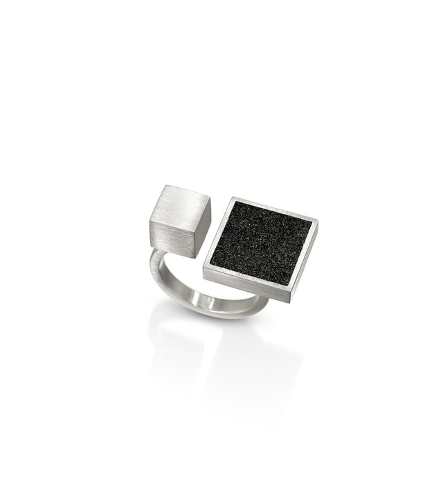 This architectural ring inspired by Theo van Doesburg combines the raw industrial beauty of concrete, set in brushed stainless steel for a striking contrast of textures. The bold geometric design brings De Stijl modernism to your everyday style,