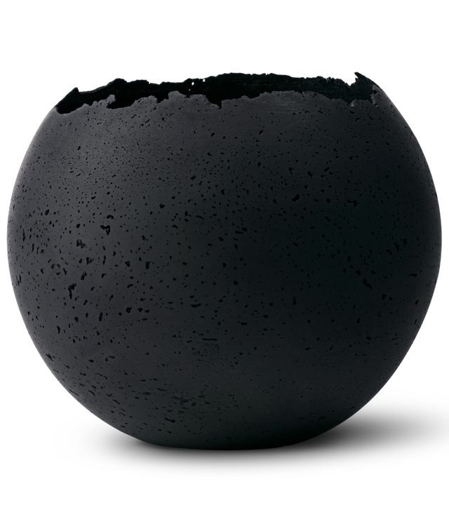 Hand-crafted black concrete vessel with a live-edge opening, designed for use as a planter.
