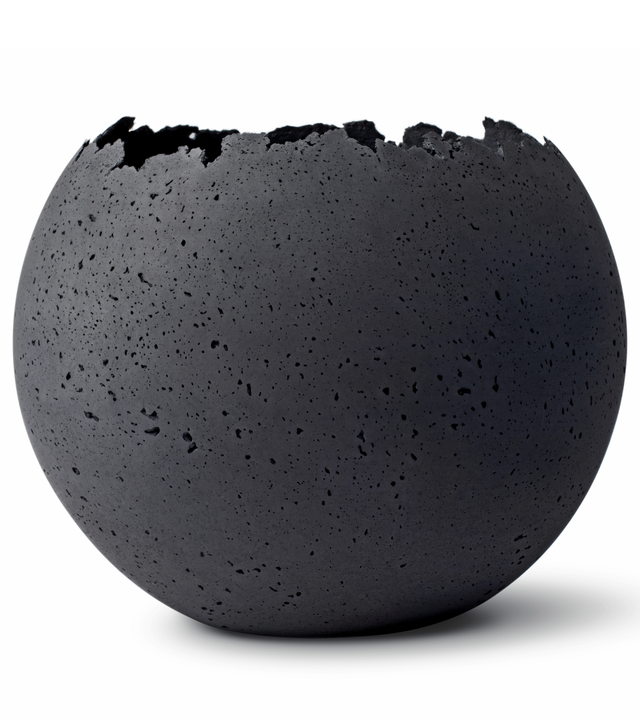 A charcoal-tinted concrete vessel with a live-edge opening