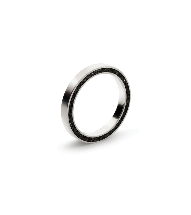 Diamond dust-and-concrete set into the side of a thin stainless steel ring.