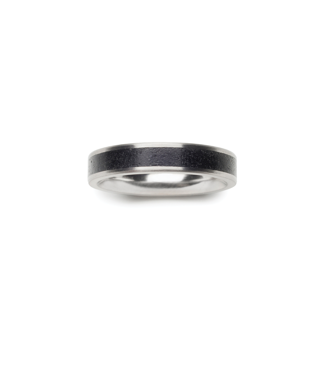 Top view of black concrete set in between stainless steel ring bands.