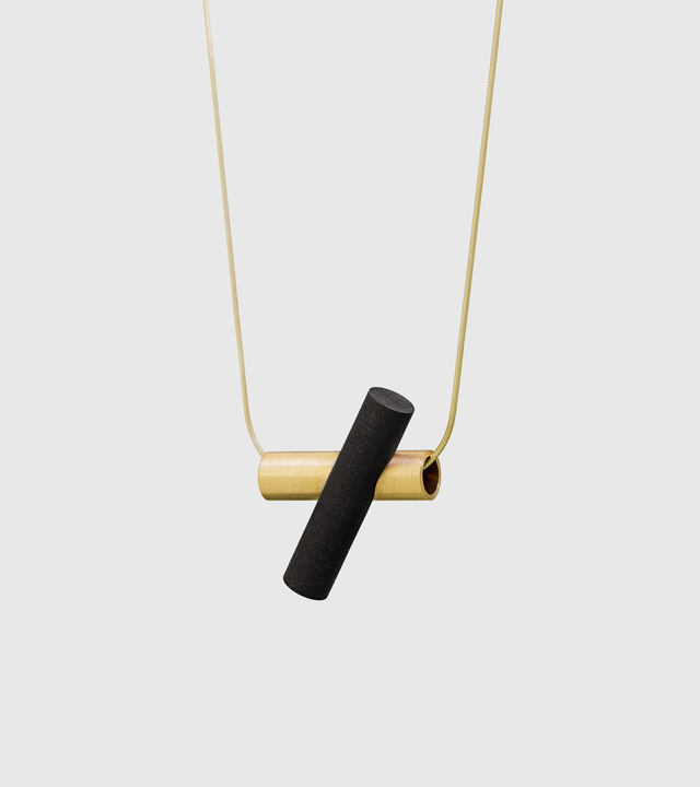 Profile photo of solid 14k gold and black-tinted concrete necklace.