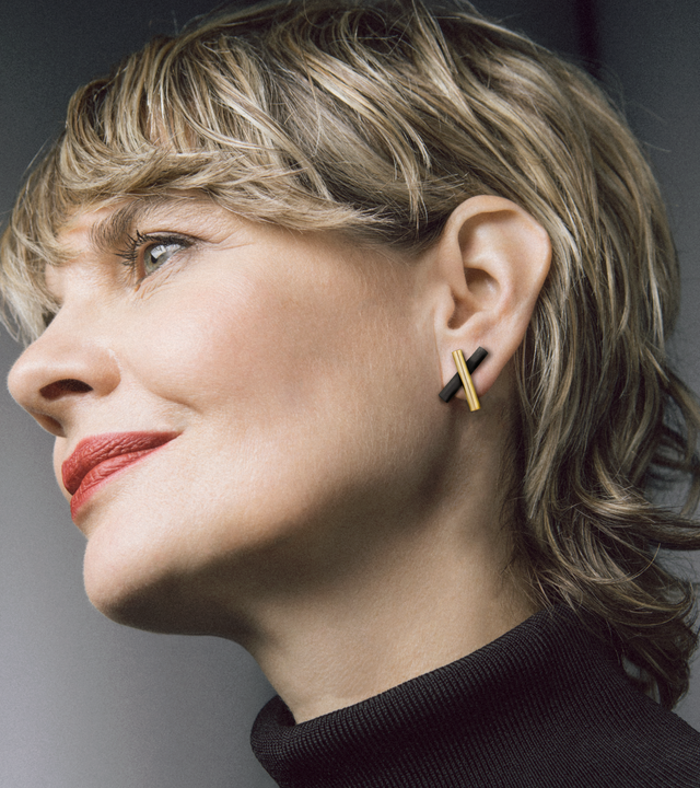 Model wears 14k gold and black concrete earring studs.