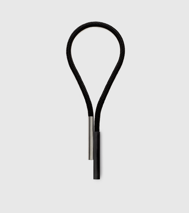 a large statement necklace of black concrete and stainless steel with nylon rope from the KONZUK Unity collection