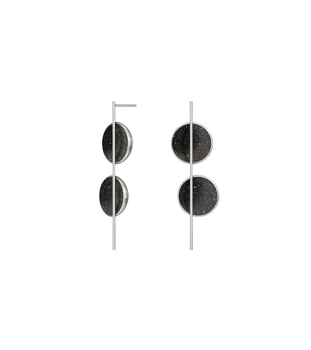 The Arago earrings sparkle with diamond dust infused black concrete set into two asymmetrically placed stainless steel dome connected behind a vertical steel post.