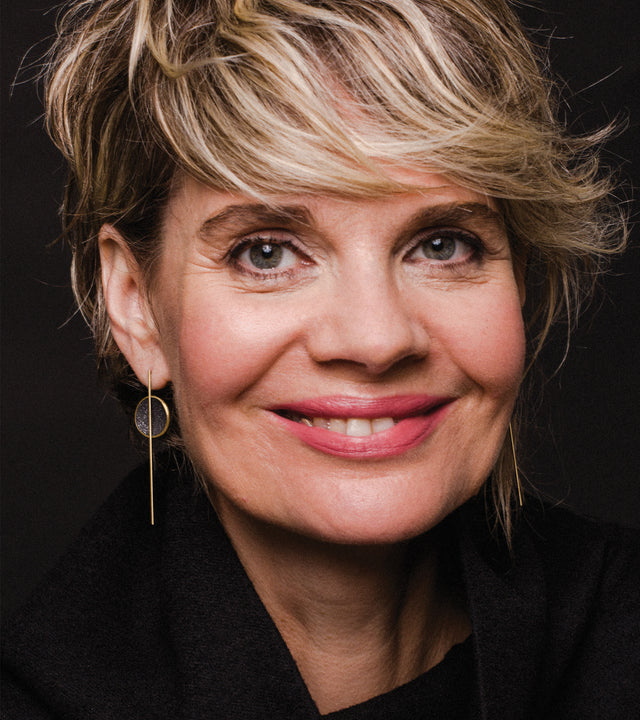 Modern jewelry featuring concrete and diamond dust set into a solid 14 karat gold dome architecturally suspended off centered from a vertically orientated steel post.