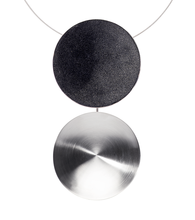 Two large shallow stainless steel domes make an impact on their own but are elevated with the addition of diamond dust infused concrete lining one.