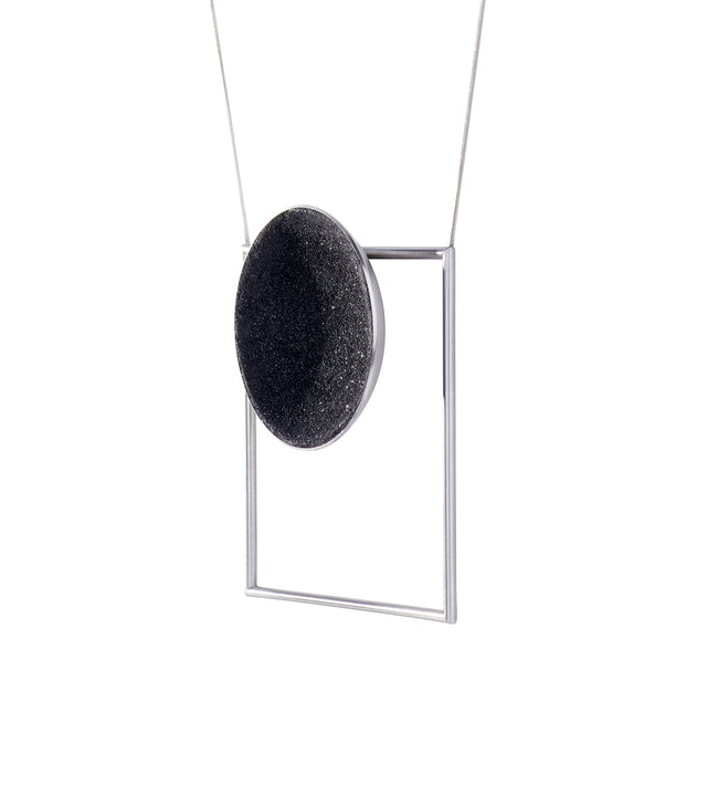 Modern necklace combines the geometry of a large stainless steel dome lined with the sparkle of diamond dust encrusted concrete suspended onto a minimalist steel square frame.