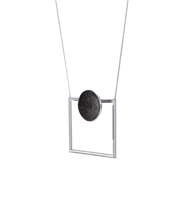 Modern necklace combines the geometry of a smaller stainless steel dome lined with the sparkle of diamond dust encrusted concrete suspended onto a minimalist steel square frame.