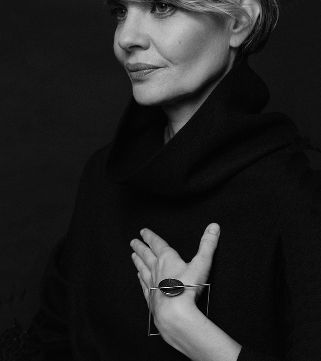 The minimalist Frama Minor bracelet sparkles with diamond dust and black concrete set into a small stainless steel dome architecturally suspended inside a minimalist steel square frame.