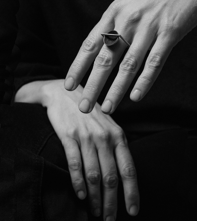 Diamond dust sparkles from inside a concrete lined stainless steel dome suspended from a minimalist square steel ring.