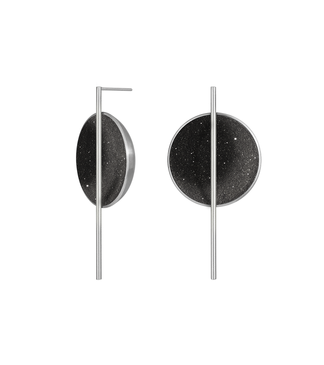 The Linnea Major statement earrings sparkle with diamond dust and black concrete set into a stainless steel dome architecturally suspended behind a minimalist steel post.