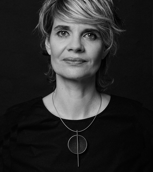 Diamond dust sparkles from inside a concrete lined stainless steel dome intersected by the bauhaus like detail of a steel post suspended from a steel necklace cable.