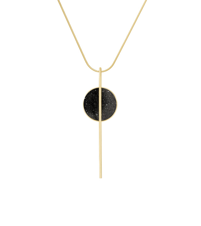 Bauhaus inspired geometry in a simple elegant necklace, the Infini necklace features a circular concrete dome infused with shimmering diamond dust, dramatically bisected by a sleek gold bar that extends into a linear drop element, all suspended from a delicate gold chain. The diamond dust catches and reflects light beautifully, adding subtle sparkle to the textured concrete surface while the lustrous gold provides a striking contrast that elevates the industrial material into refined luxury.