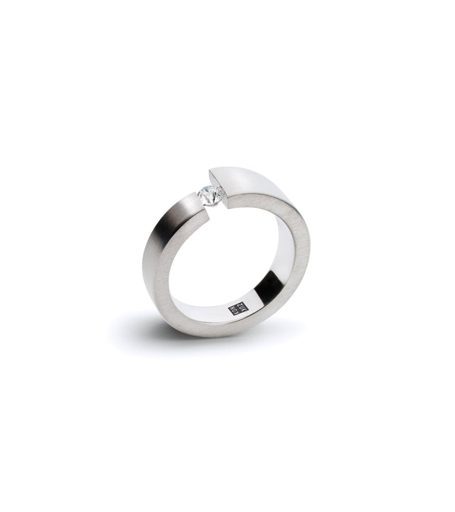 an offset stainless steel engagement ring holds a .10ct diamond