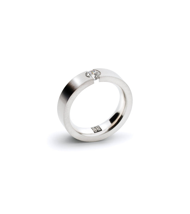 A sleek engagement ring featuring a .30ct diamond tension set in a stainless steel or platinum band.