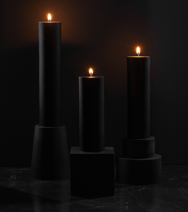 brutalist monumental sized concrete candles with black beeswax pillar candles