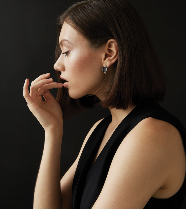 The elegant Juno Minor earrings sparkle with diamond dust and black concrete lined stainless steel dome a minimalist steel post.