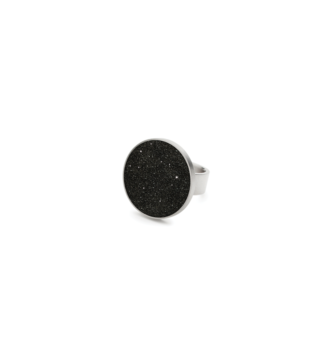 The Antares stainless steel ring set with diamond dust infused black concrete.