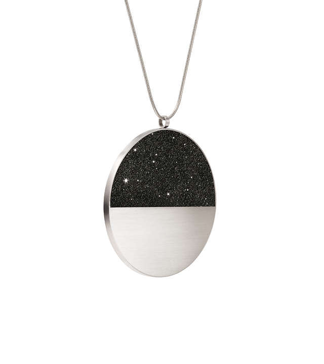 The statement sized Mira Major concrete and diamond dust necklace achieves minimalist beauty with modernist jewelry design that echoes architectural principles of balance, rhythm and harmony.