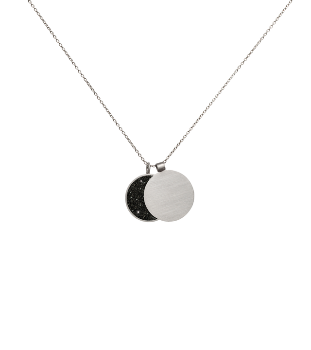 This minimalist overlapping double pendant in concrete, diamond dust and stainless steel hangs centred and shapes the phases of the moon depending on how the piece hangs.
