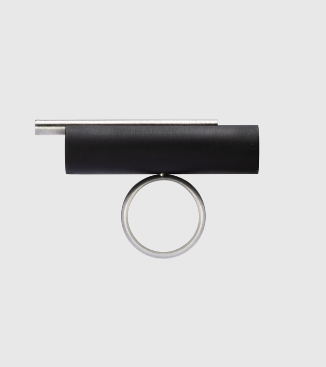 This striking Unity Tandem ring features a cylindrical concrete element set within a sleek stainless steel band, creating a bold architectural statement piece. The combination of industrial materials offers exceptional durability—stainless steel is highly resistant to tarnishing and corrosion, while concrete provides unique texture and character that develops beautifully over time.