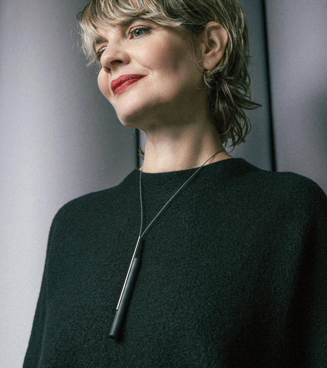 The larger Tandem 8 necklace encapsulates minimalist design. A natural or black concrete cylinder is suspended in unison connected with a brushed stainless steel rod. Both hang elegantly from a nylon coated stainless steel cable.
