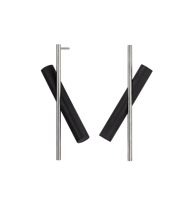 These sleek linear earrings feature a modern geometric design with elongated bar elements that create an elegant, minimalist aesthetic. The contrasting finishes of brushed stainless steel and concrete add visual interest and dimension while maintaining a sophisticated, understated look. Their lightweight construction makes them comfortable for all-day wear, and the simple drop style effortlessly transitions from casual daytime outfits to evening attire. The clean lines and contemporary design appeal
