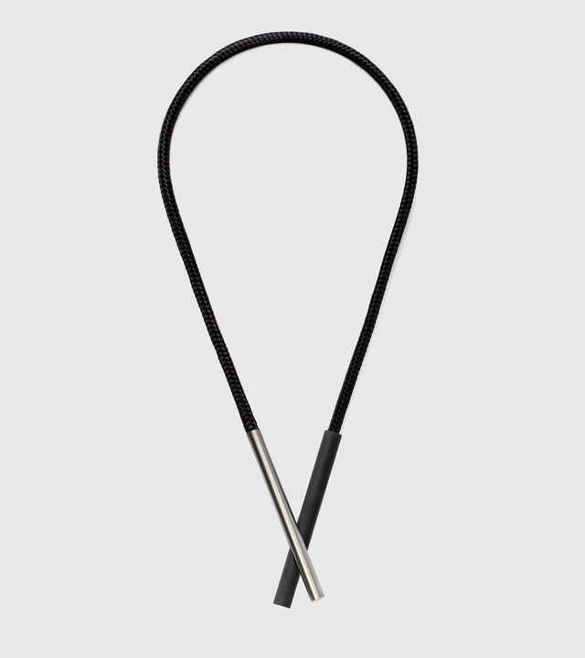 This sleek necklace features contrasting concrete and stainless steel cylinders elegantly suspended from a stainless steel cable, creating a refined minimalist statement. The architectural pairing of materials offers both visual interest and exceptional durability—the stainless steel resists tarnishing and maintains its lustrous finish, while the concrete provides unique texture that adds organic character.