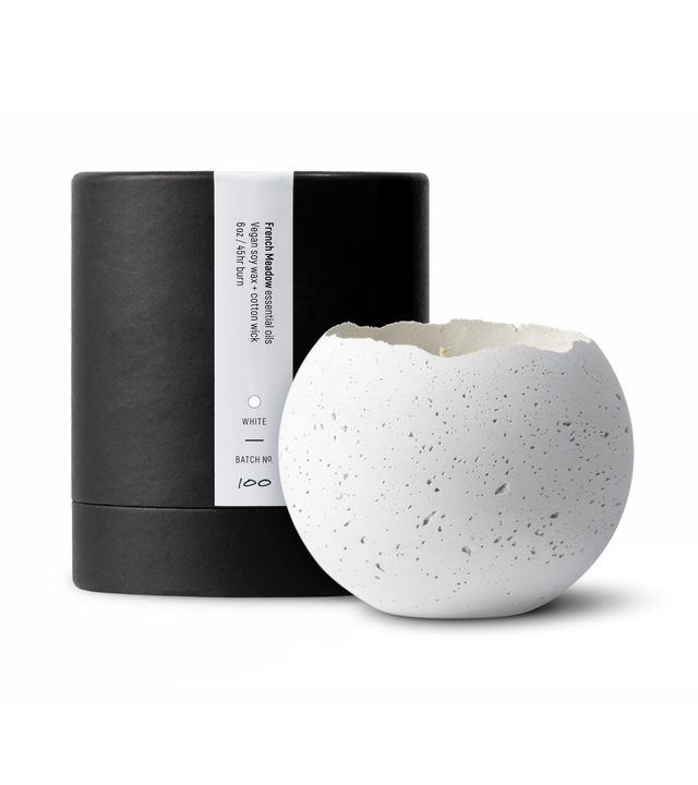 white concrete orbis candle beside a black tube packaging from KONZUK HouseHold