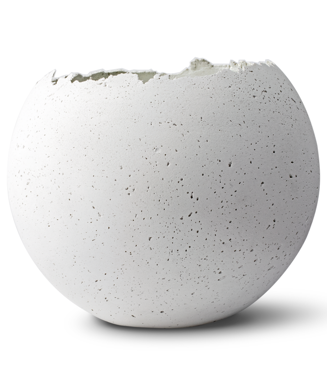 Hand-crafted white-tinted concrete vessel with a live-edge opening, showcasing a unique, fragmented geometric shape.