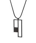 side view of a Black geometric pendant on a black cord against a white background from the KONZUK Artus Ratio collection