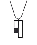 Black geometric pendant on a black cord against a white background from the KONZUK Artus Ratio collection