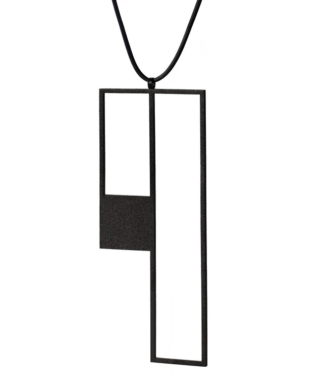 side view of a long sculptural black powder coated stainless steel geometric necklace from KONZUK Artus Ratio collection