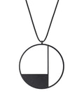 KONZUK Artus circular Necklace with a black and white geometric pendant on a rubber cord