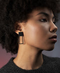 large statement black rectangular earrings from the KONZUK Artus collection on a model