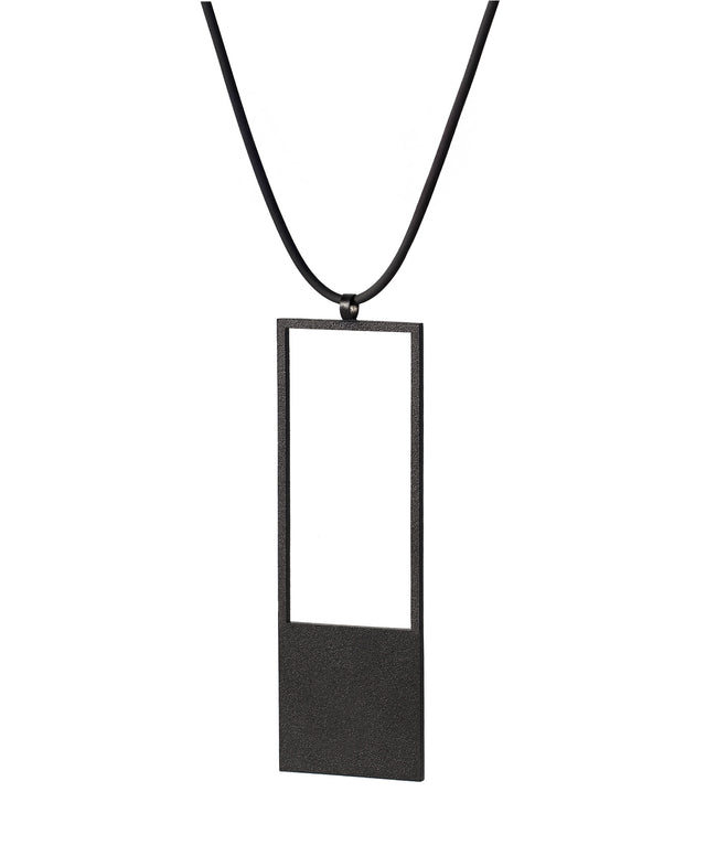 side view of a black minimalist rectangular geometric necklace with a rubber cord from the KONZUK Artus collection Sp2
