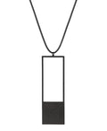 a black minimalist rectangular geometric necklace with a rubber cord from the KONZUK Artus collection Sp2