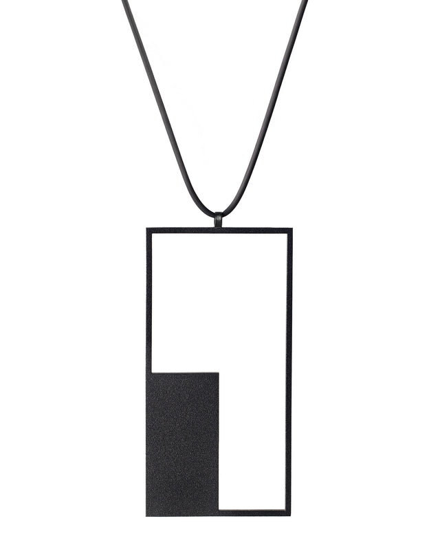 a longer geometric and minimalist rectangular necklace in black powder coated stainless steel from the KONZUK Artus collection