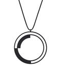 a large statement necklace from the KONZUK Artus collection featuring a round geometric form of black powder coated stainless steel.