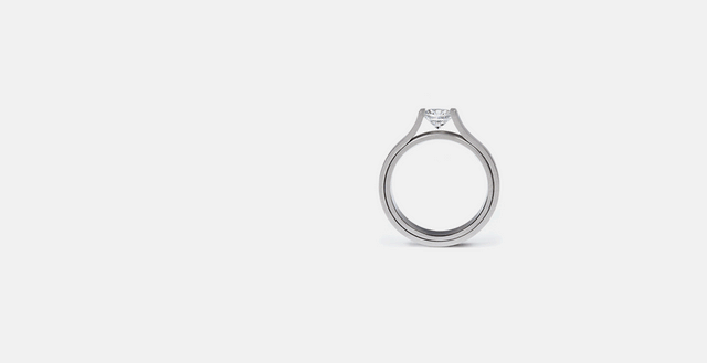 Diamondis tension set into modernist platinum ring. 